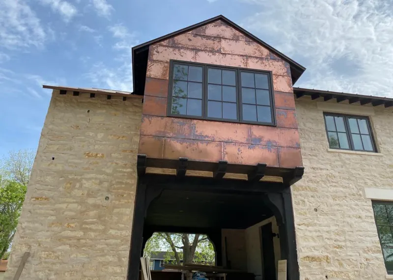 Copper metal panel facade on a stone building for Metal Roof Coating in St. Martinville