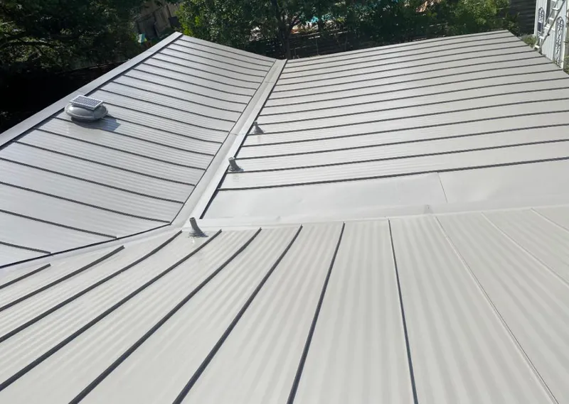 Solar attic fan installed on a metal roof for Roof Ventilation in St. Martinville