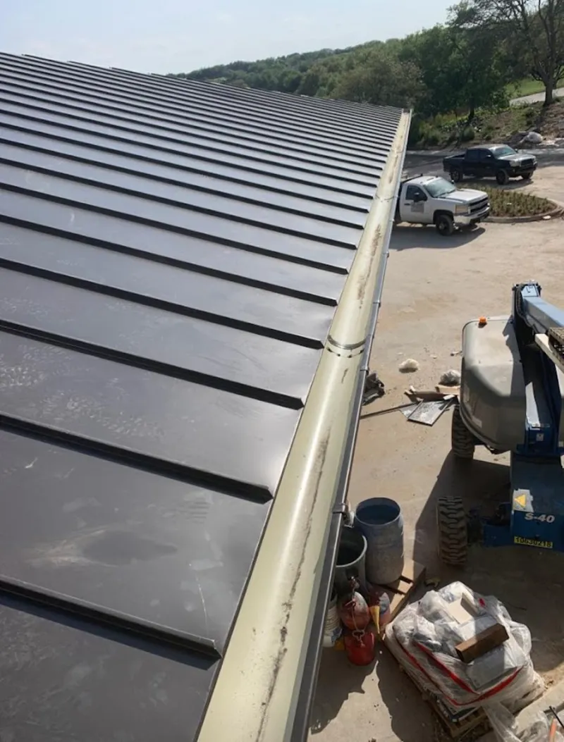 Standing seam panel and gutter detail on a metal roofing jobsite in St. Martinville